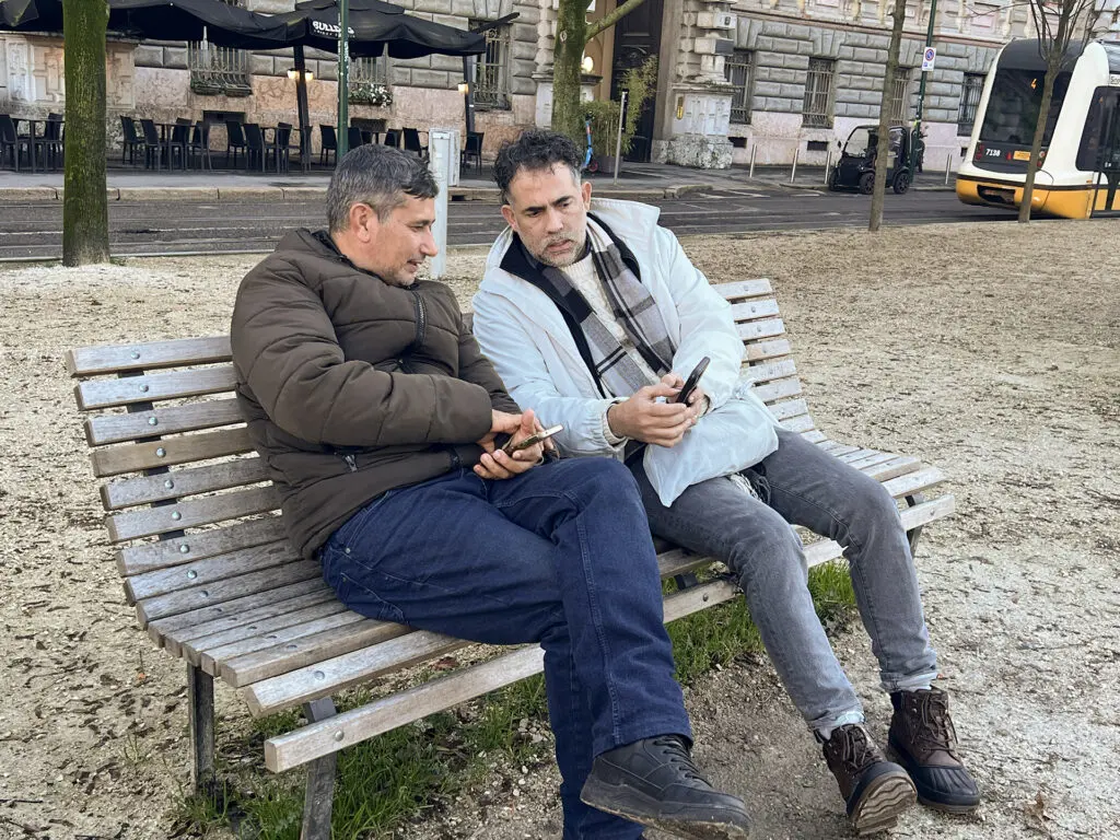 Southern Baptist missionaries and volunteers sharing gospel booklets with visitors at a hospitality point during the Milano Cortina 2026 Winter Olympics in Italy