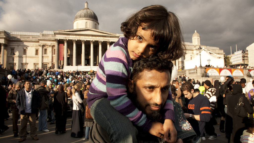 A father carries his daughter in Trafalgar Square in the center of London at a festival called ‘Eid in the Square.’ The Muslim festival of Eid-ul-Fitr (Eid) marks the end of Ramadan, a period observed simultaneously by millions of followers of Islam around the world.