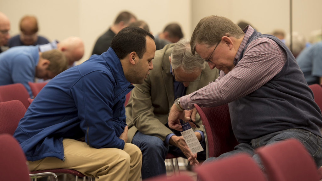 During a time of prayer for unengaged unreached people groups, IMB trustee Dick Avey (right, from Arkansas) prays with Edgar Aponte (left), vice president of mobilization, and Phil Nelson, alumni network leader. Trustees prayed specifically for the Ukrainians of Brazil and the Nuer of South Sudan. (IMB Photo by Roy Burroughs)