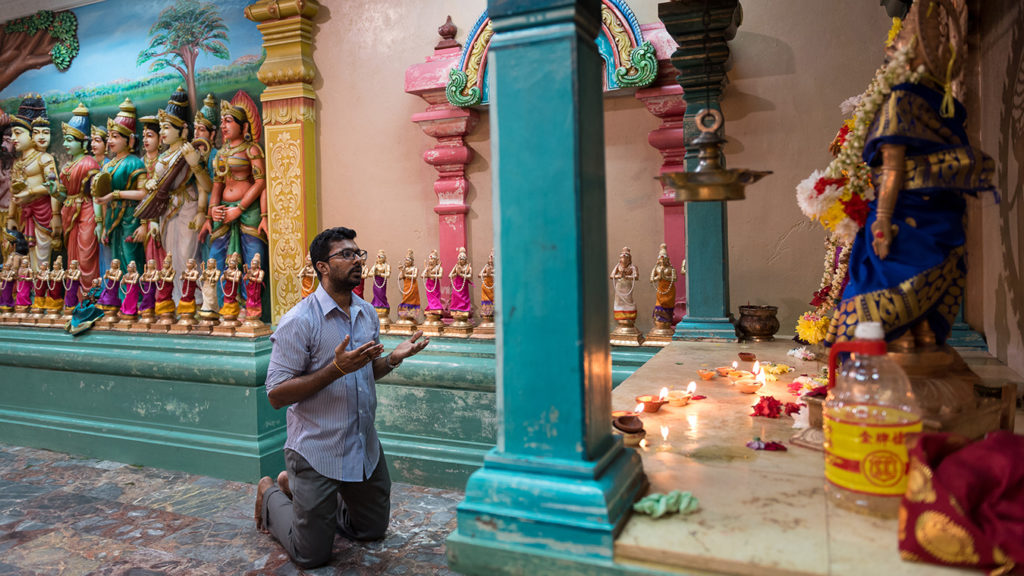A man prays in a Hindu temple in Kuala Lumpur.
