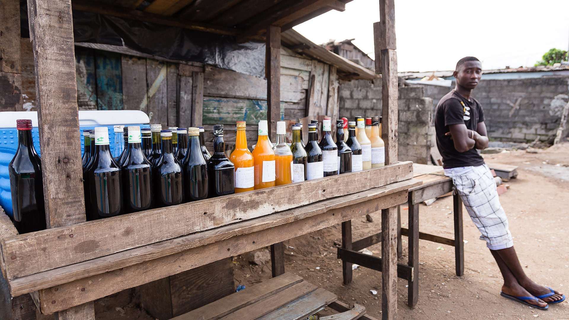 A young man in Abidjan, Ivory Coast sells a natural medicinal brew. 