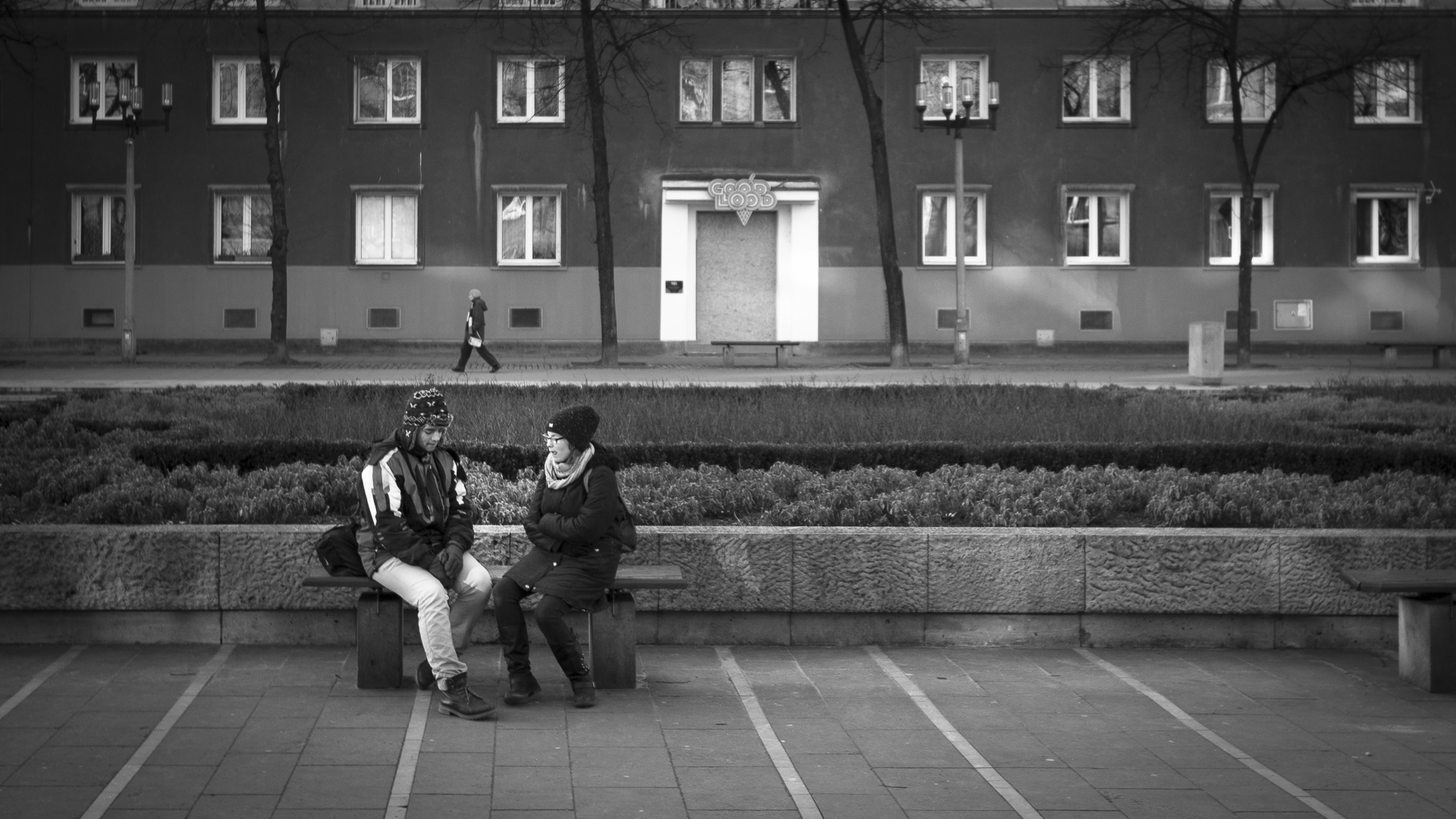 Friends talk in front of an apartment in Nowa Huta. 