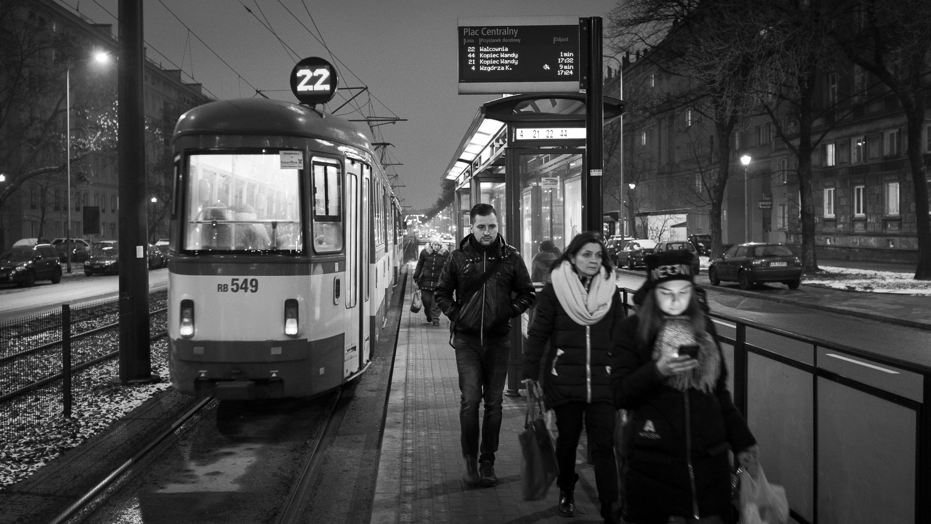 Commuters disembark from a tram in Nowa Huta