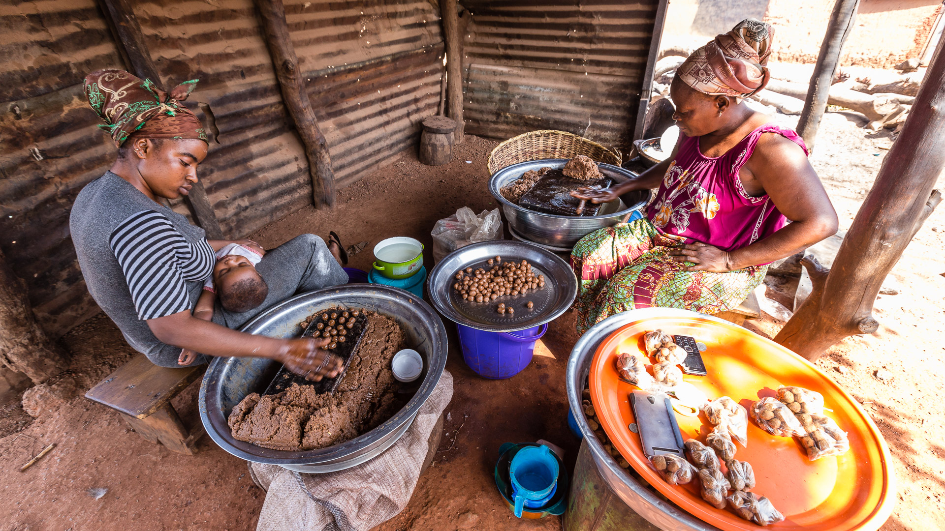 A Mamprusi woman and her daughter prepare kulikuli to sell at a local market in northern Ghana