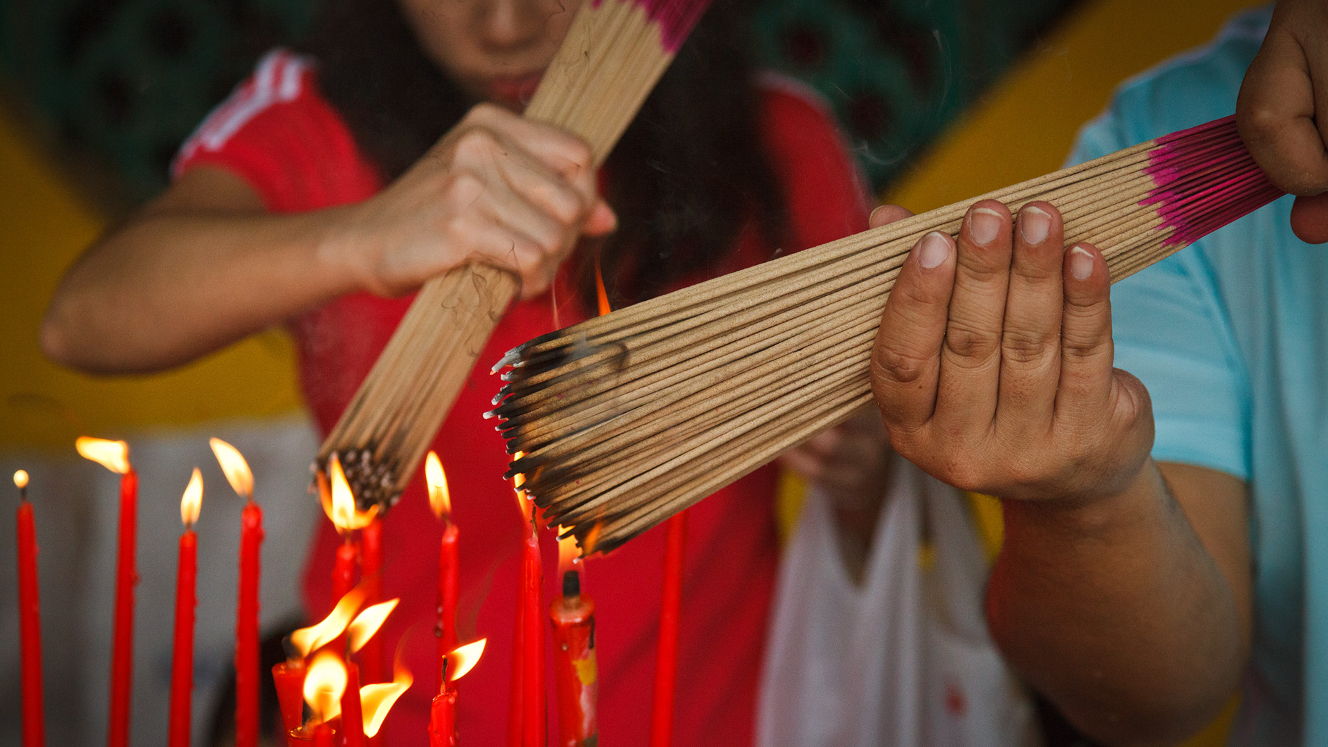 Devotees light incense in a Buddhist temple. 