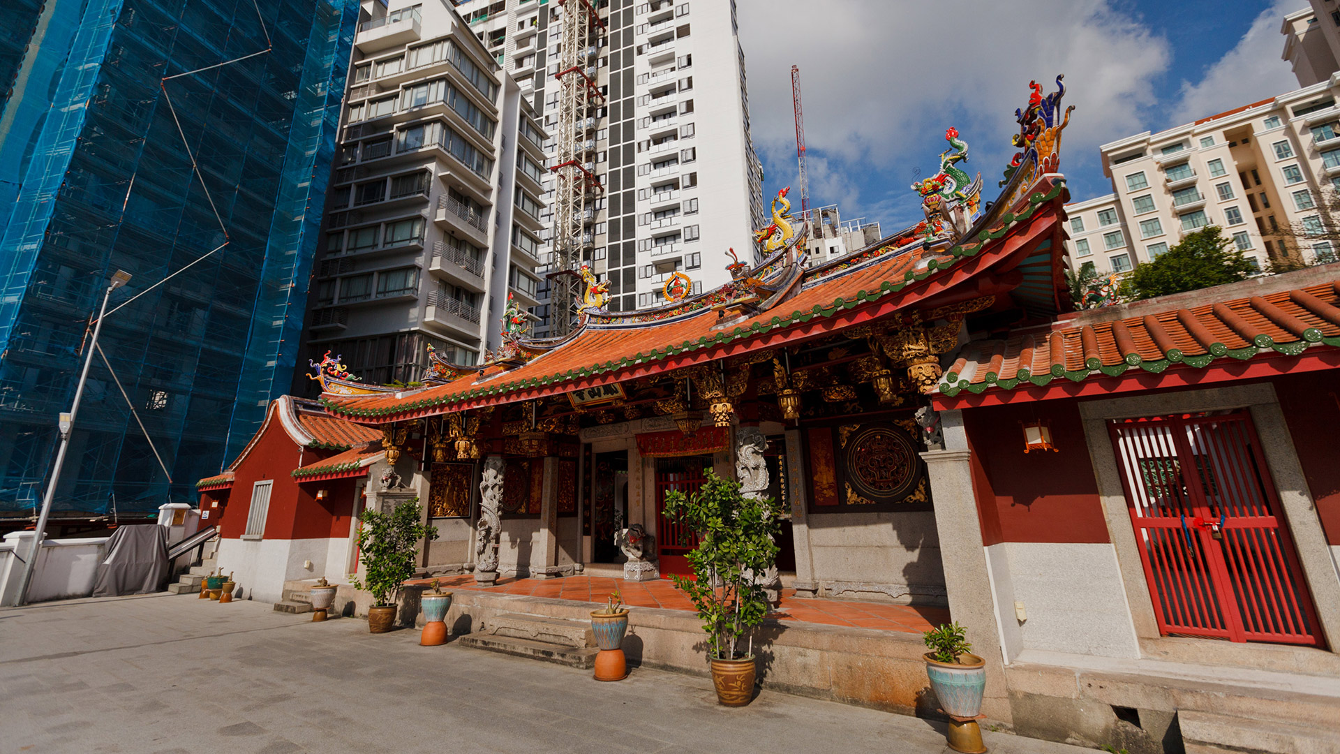 A Buddhist temple sits beside skyscrapers in Singapore. 
