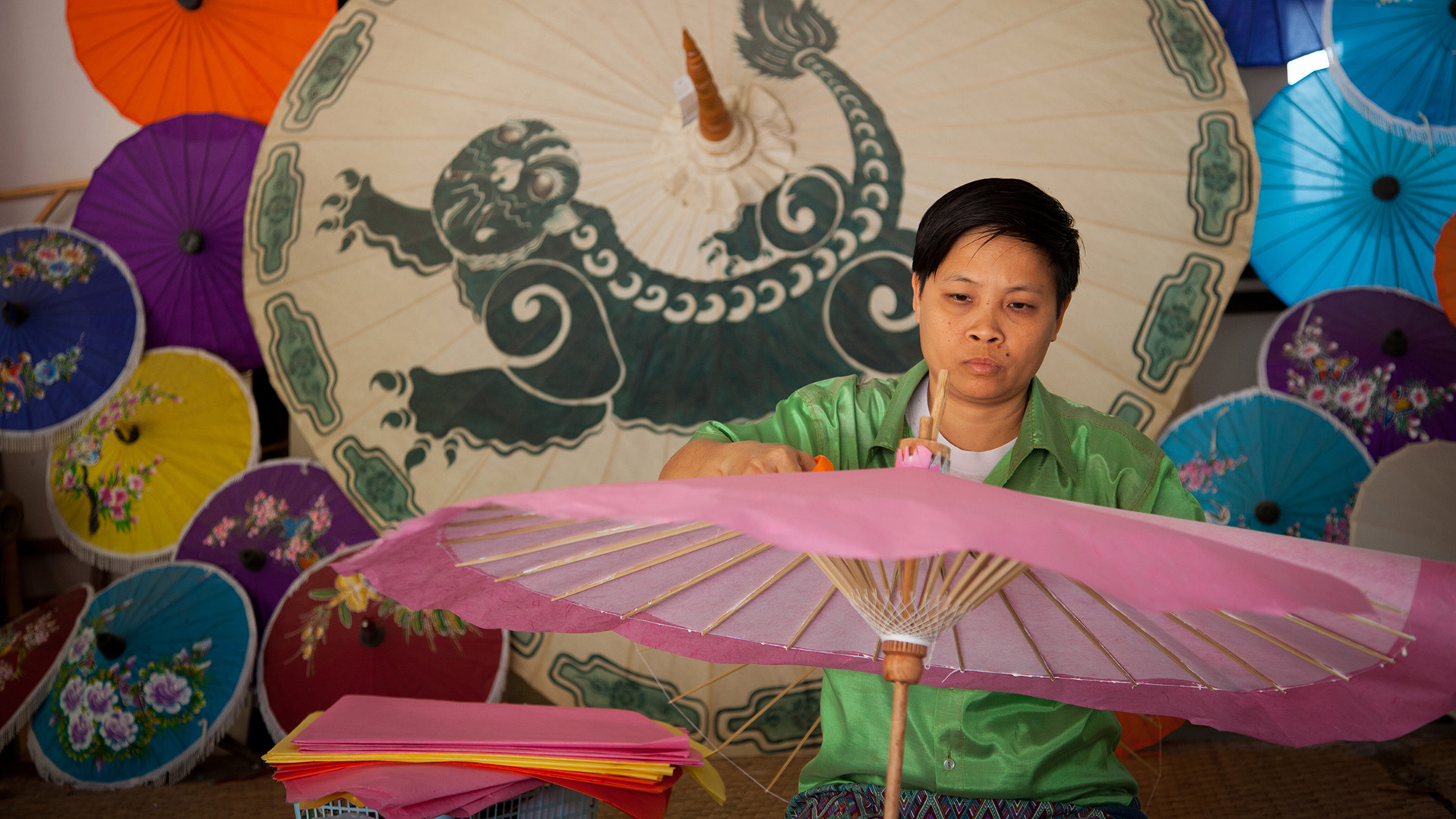 A Thai woman makes umbrellas. 