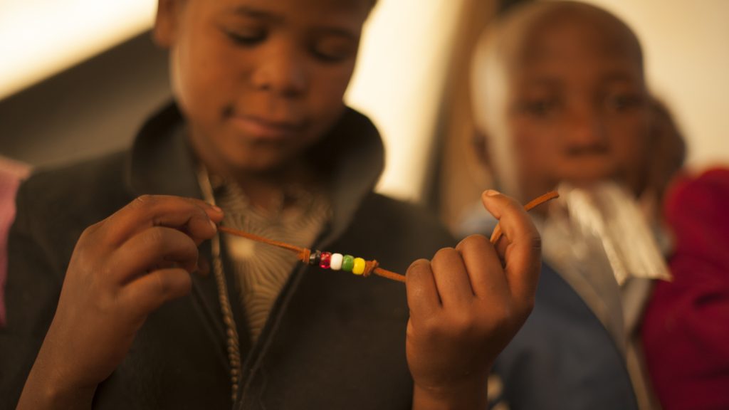 Basotho children in Lesotho learn to make salvation bracelets.