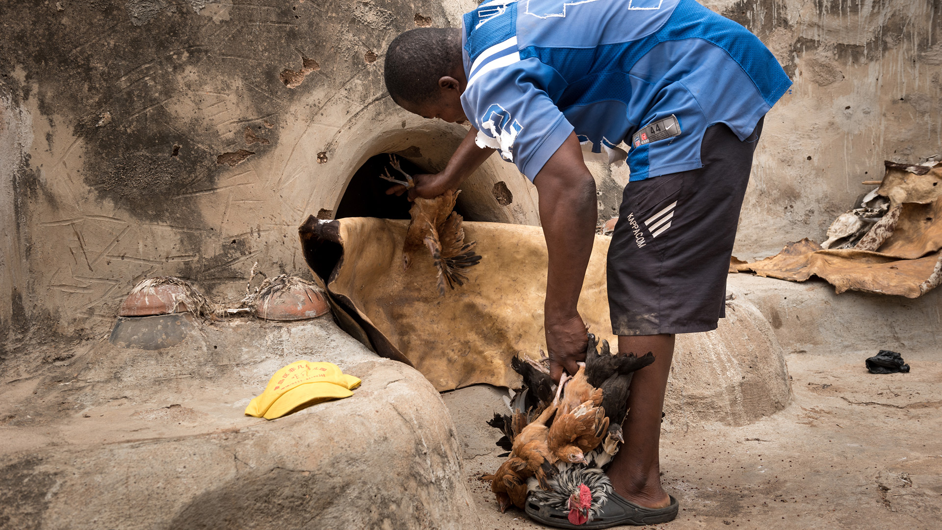 A man offers an animal sacrifice to a shrine. 