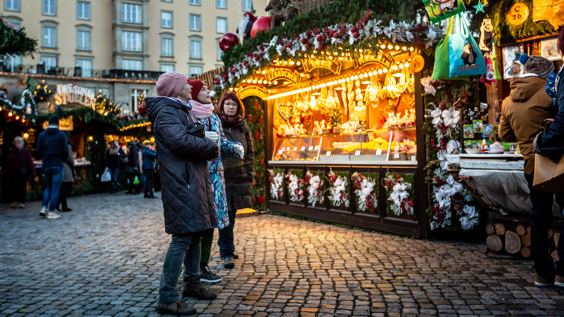 Visitors are delighted by the handcrafted toys at a stand at the Striezelmarkt Christmas market in Dresden, Germany.