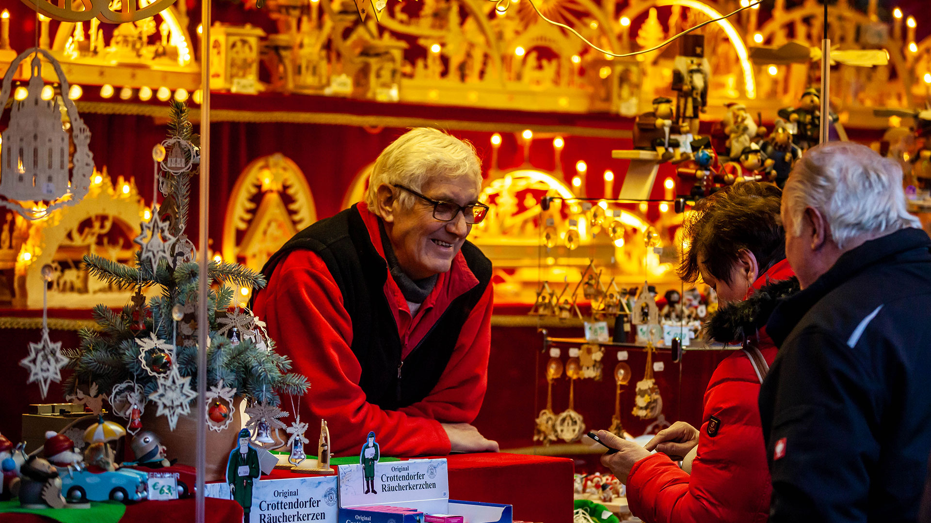 A man sells traditional Erzgebirge Schwibbogen Arches at the Streizelmarkt Christmas market in Dresden, Germany.