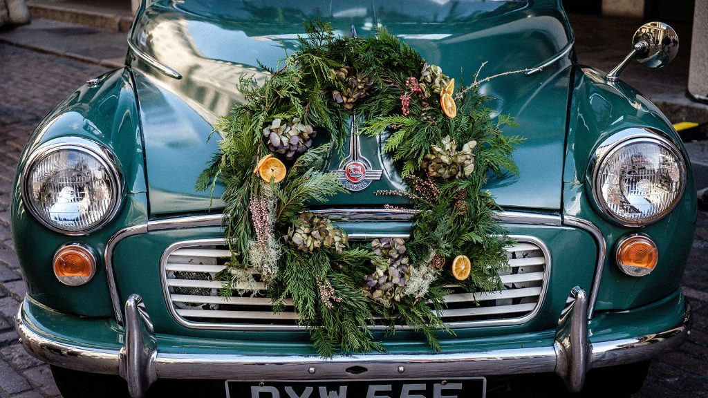 A traditional Christmas wreath decorates a car in London.