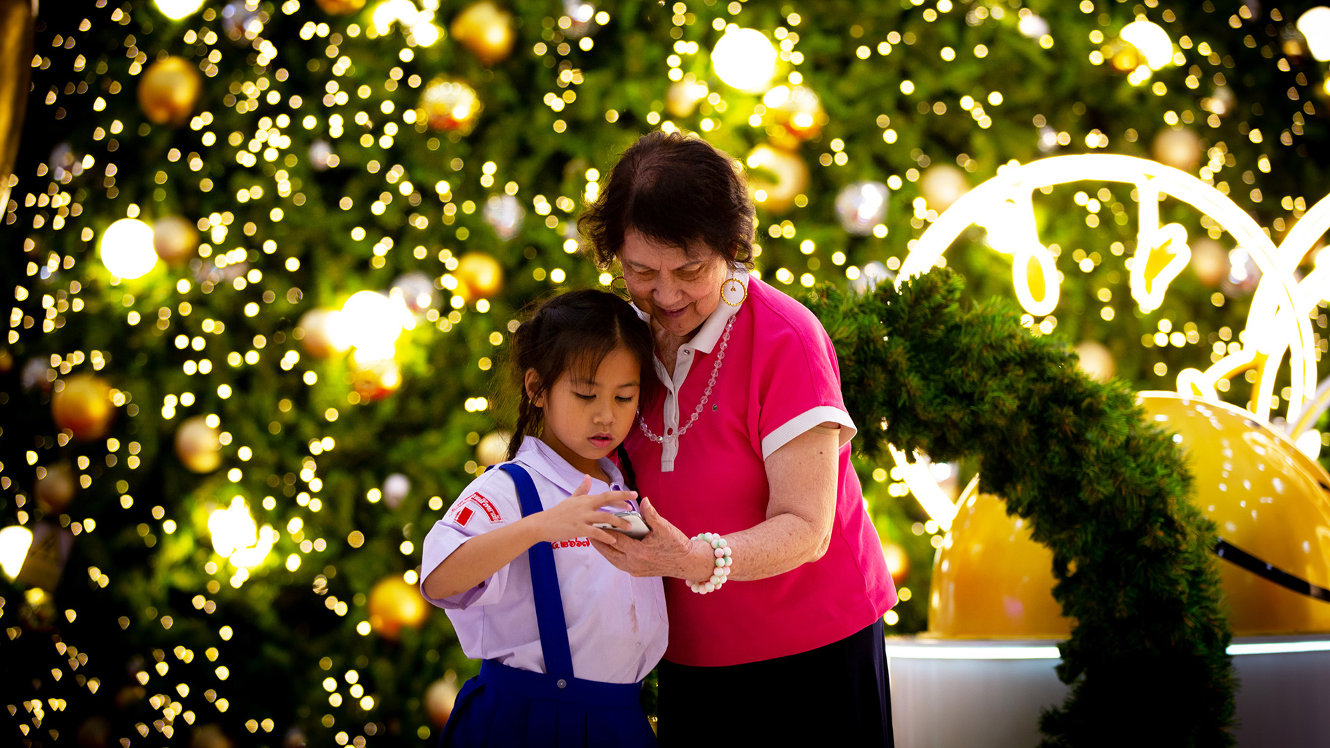 In Southeast Asia, a grandmother shares a precious moment with her granddaughter at a mall where the two posed for a picture. 