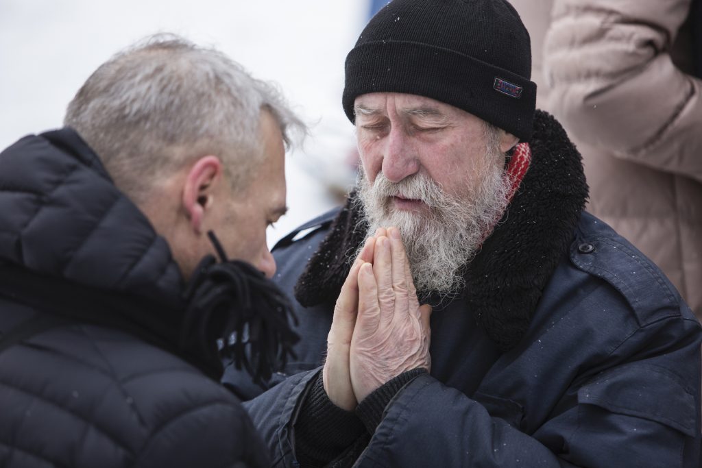 Ukraine men praying. IMB Photo