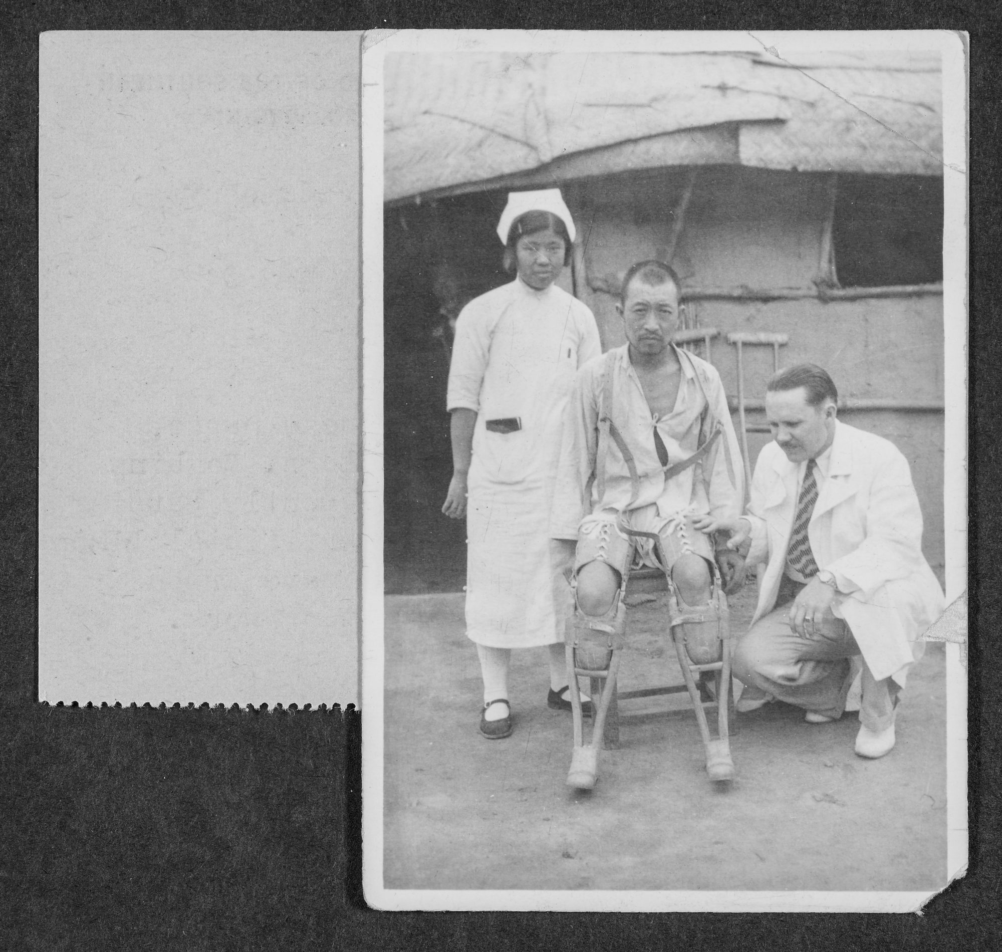 Dr. Hugh Humphrey and a Chinese nurse examine a patient with artificial legs after his injuries from a war bombing necessitated amputations.