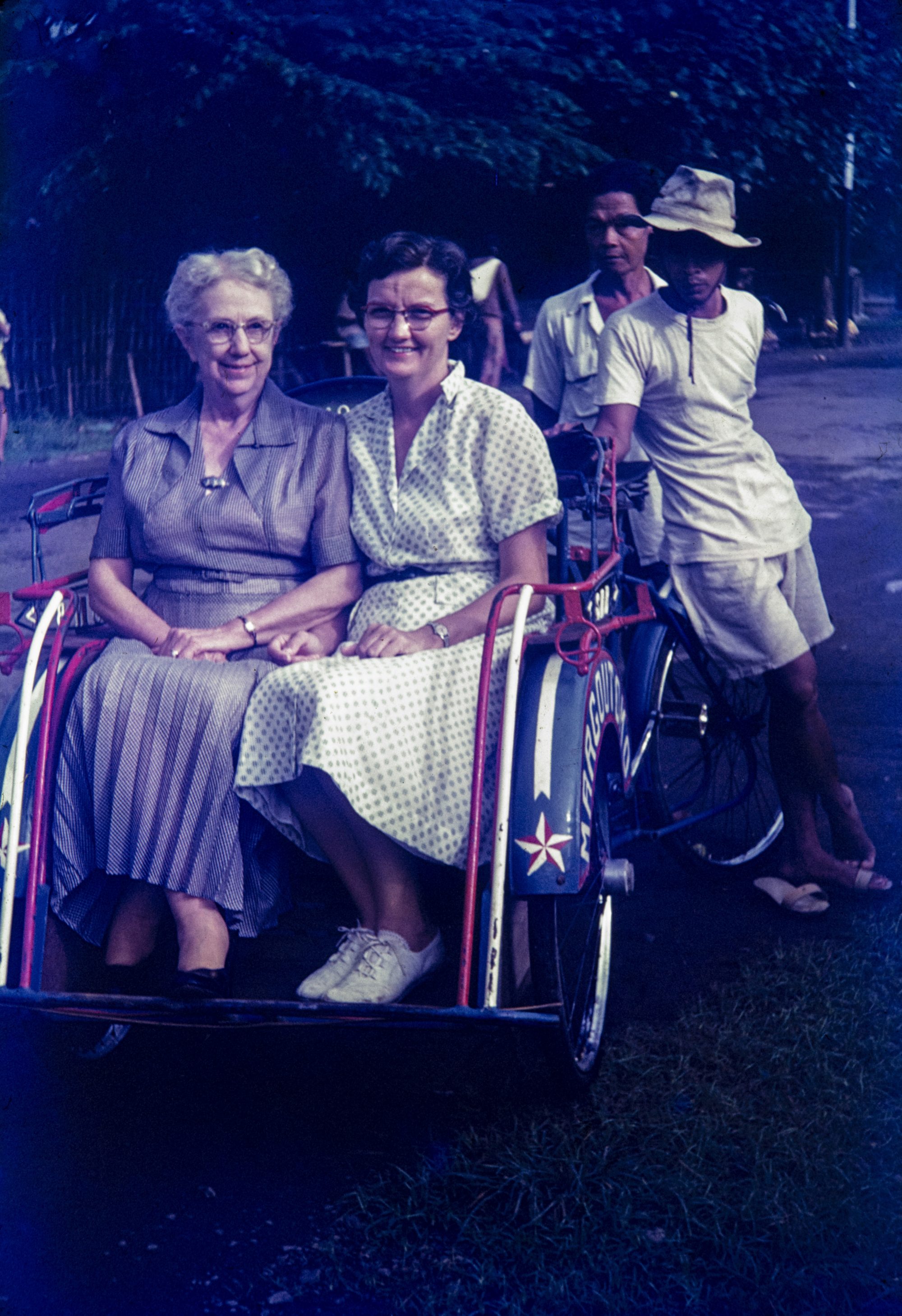 Catherine Walker and her mother, Clara, ride a local form of transport in Kediri, Indonesia, in 1955.