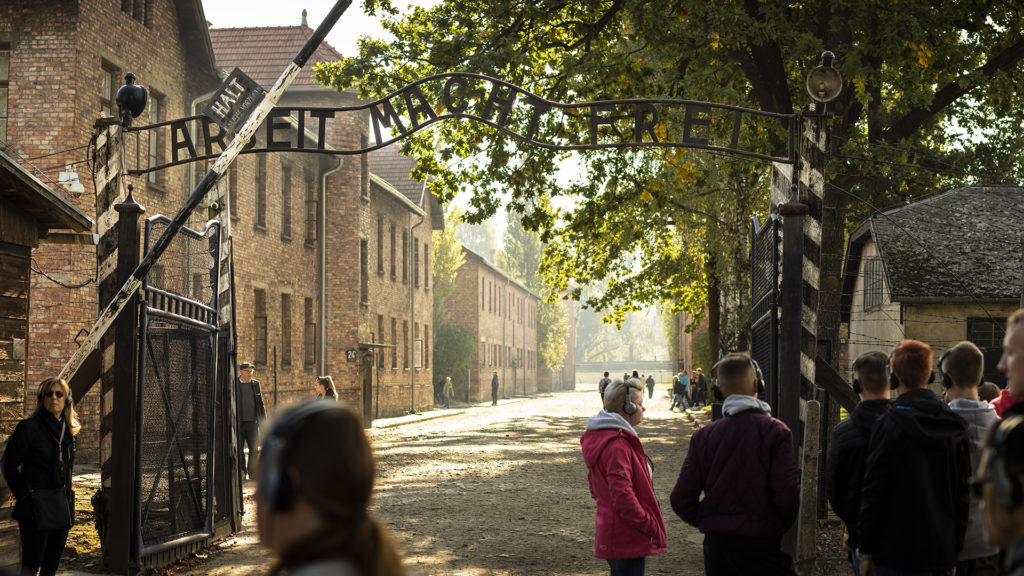 Above the gate to the Auschwitz concentration camp are the words “Work Makes Free.” This is a famous scene from World War II and the Holocaust. Strangely, time has made the scene somewhat less visible as the trees have grown up and the gate no longer stands as stark against the sky as in my memory of photos I have seen.