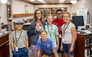 Ann Lovell, former IMB missionary and current internal communications director for IMB, poses with a group of kids from Southern Hills Baptist Church of Oklahoma City, OK.