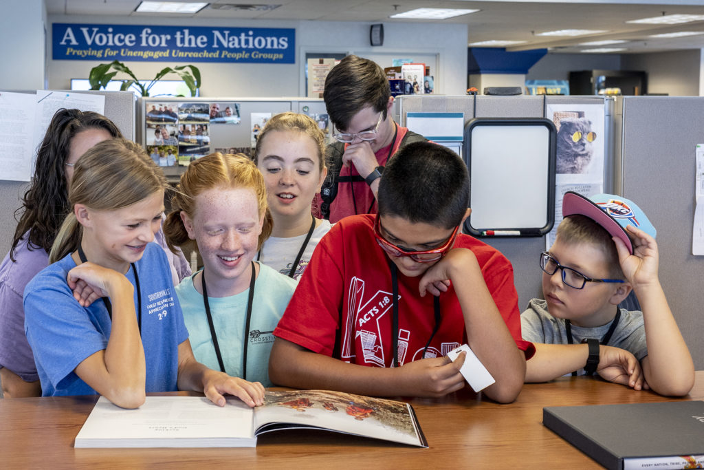 During their tour of the IMB headquarters, a group of fifth and sixth graders from Southern Hills Baptist Church in OK pause to look through Every Nation, Tribe, People and Language, IMB's commemorative coffee table book.