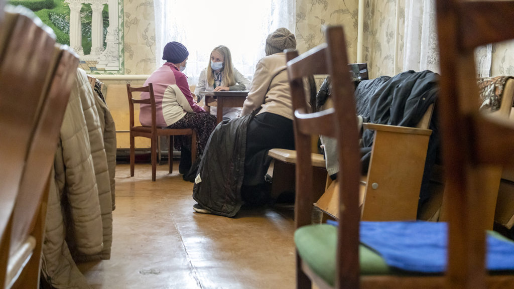Svieta, a Ukrainian doctor, visits with a patient in a mobile clinic hosted by a church. Medical care is scarce in war-torn areas of eastern Ukraine. IMB Photo