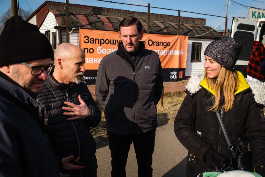 IMB President Paul Chitwood (center) and IMB missionaries (left) talk with refugees crossing the Ukraine-Poland border. Baptists put immediate ministry plans into action to best serve those fleeing the war. IMB photo