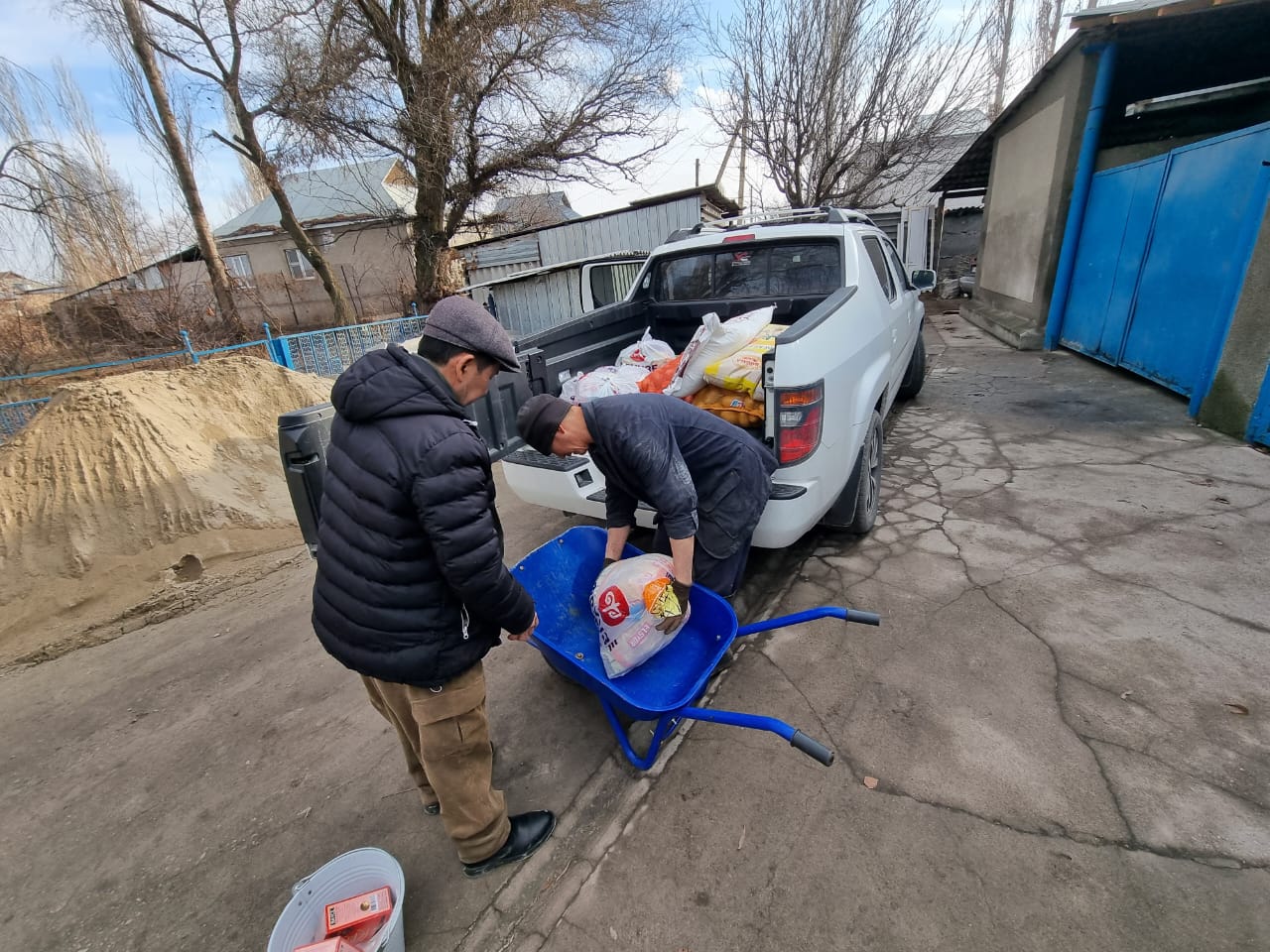 Two men load supplies for House of Hope into the back of a pickup truck. House of Hope is a halfway house in Central Asia for recovering alcohol and drug addicts. IMB Photo
