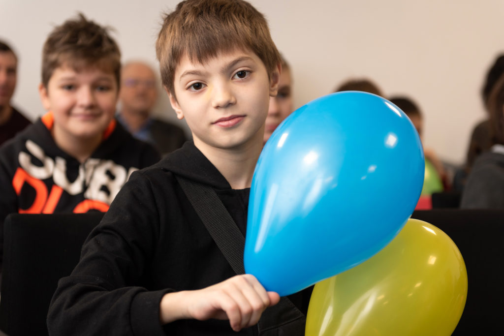 A Ukrainian boy holds a balloon at a camp hosted by Christians in Poland. IMB Photo
