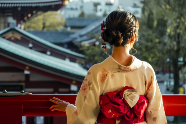 A Japanese woman looks over a balcony in Sensō-ji temple in Tokyo, Japan.