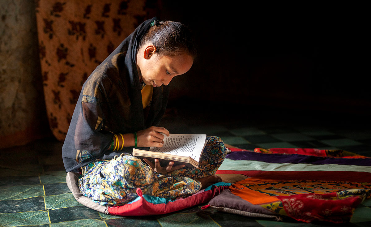 A Nepali Christian holds a worship songbook during a worship service in Hokse, Nepal.